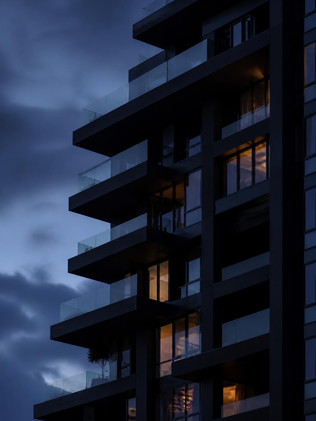 Luxury multifamily tower facade at blue hour
